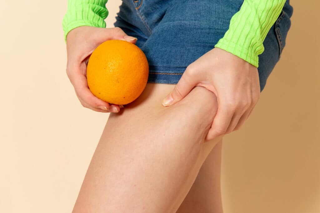 front view young beautiful female green shirt holding orange cream wall fruit model woman mellow